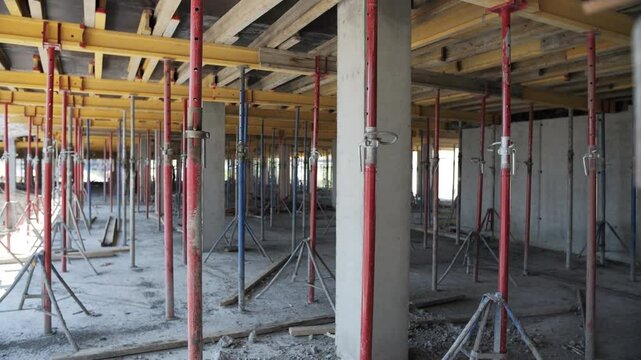 Concrete floor under construction with formwork and support props