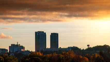 Silhouette of constructing buildings against amazing sunset red sky.