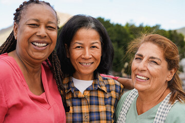 Happy elderly multiracial women smiling on camera - Diverse female friendship, senior people and...