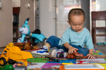Fototapeta premium little boy playing with toys