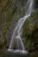 Fototapeta premium Long exposure shot of a waterfall in the forest.