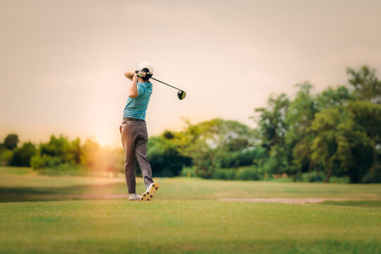 Professinal golf player on golf course. Pro golfer taking a shot. - Powered by Adobe