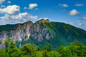 2025-06-03 VIEW OF MOUNT SI WITH LUSH TREES AND EXPOSED ROCK ON THE SIDE OF THE MOUNTAIN WITH A NICE SKY IN NORTH BEND WASHINGTON