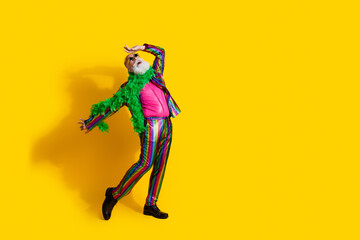 Photo of charismatic man showman wear stylish striped outfit dance night club theme party isolated on yellow color background