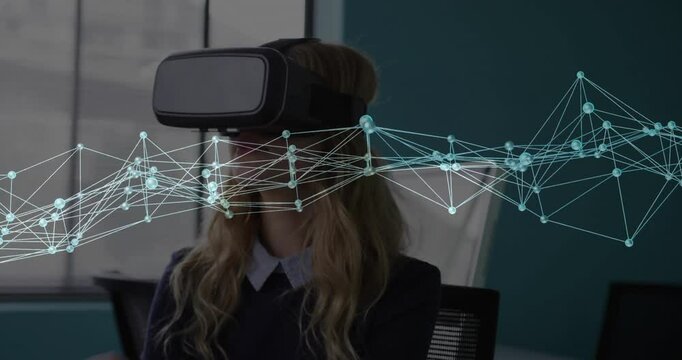 Office worker reaching up adjusting VR headset strap and activating network overlay in tech demo