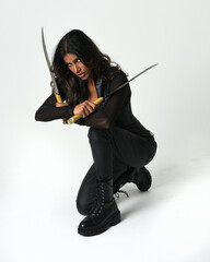 Full-length portrait of confident woman in leather armour and leather pants, boots, steampunk and...