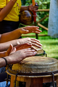 Musicians playing berimbau and atabaque in Brazilian capoeira outdoors