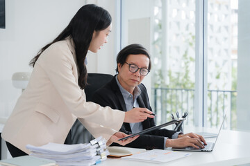 Business Colleagues Discussing Work at Desk