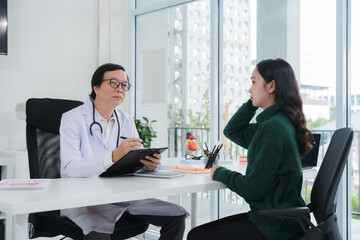 Doctor Consulting with Patient in Office