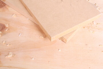 Small Cut Wood Pieces with Sawdust on Light Timber Surface