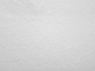 White textured surface with a subtle weave pattern, resembling canvas or fabric. The detailed...