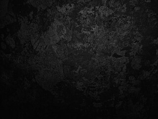 Dark textured surface with abstract patterns, featuring a mix of rough and smooth areas. The...
