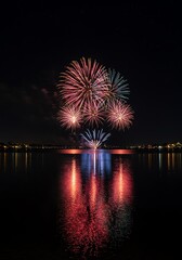Fireworks display over water at night