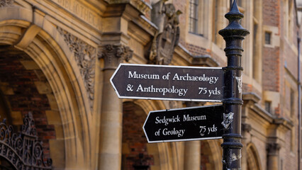 Close up view of a directional signpost indicating the Museum of Archaeology and Anthropology and Sedgwick Museum of Geology, both located 75 yards away, in the historic city of Cambridge, UK
