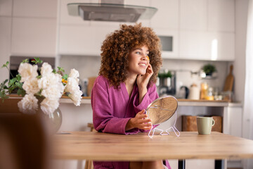 Beautiful African American Woman With Natural Hair Looking In Mirror During Morning Wellness...