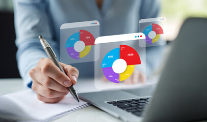 Businesswoman analyzing financial data on a laptop, with pie charts