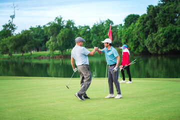 Senior Golfer and Young Golfer enjoying golf together at golf course, playing with fun in summer...