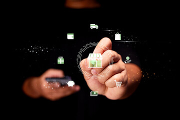 A person interacts with digital icons representing online shopping and e-commerce against a black background.