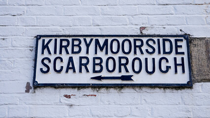 Vintage sign showing directions to Kirbymoorside and Scarborough in Helmsley, North York Moors National Park, UK