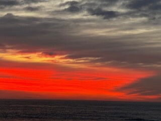 Fototapeta premium Vivid Red and Orange Sunrise Lighting Up the Morning Sky