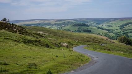Breathtaking view of a winding road leading down into a picturesque valley in North York Moors...