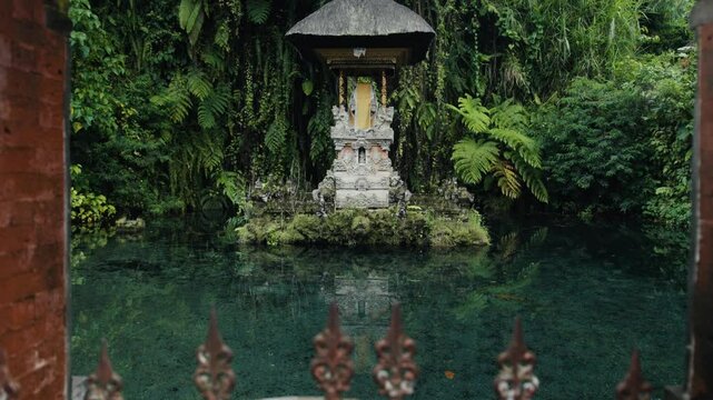 Gunung kawi sebatu temple reflecting on calm water in bali