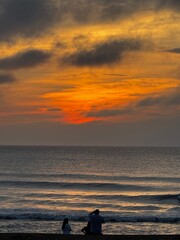 Close-Up of Family Watching Fiery Sunrise Over Calm Virginia Beach Waters