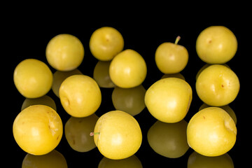 Yellow juicy plums isolated on black background, close-up.