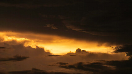 Dramatic gap in ominous storm clouds near sunset, June in southwest Florida. For background or element with motifs of illumination and visibility, weather conditions, and transition.