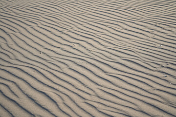 Photo of sandy surface with created wind pattern
