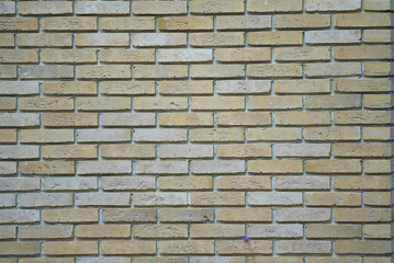 Background photo of the brick masonry light yellow, horizontal close-up
