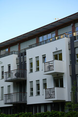 Exterior of modern white building with windows and balconies