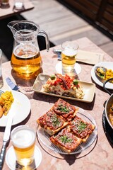 Colorful tapas spread with beer outdoors