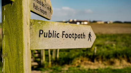 Wooden public footpath sign indicating walking route in North York Moors National Park, Whitby, showing directions for hikers and walkers
