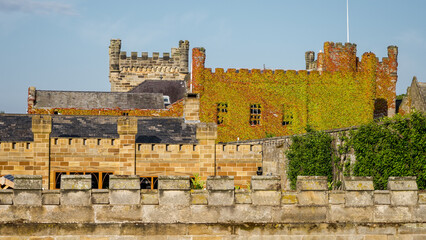 Scenic view of Whitby Abbey partially covered by colorful ivy in autumn, North Yorkshire, England
