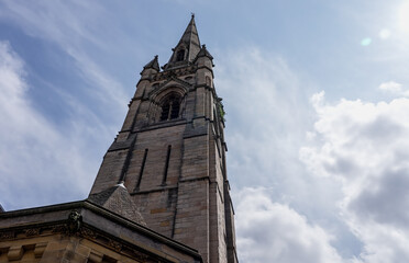 Majestic architecture of St. Nicholas Cathedral in Newcastle, UK, standing tall against a backdrop of cloudy sky