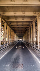 Road going under the Tyne Bridge with speed limit sign showing twenty miles per hour