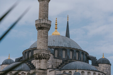Majestic sultan ahmed mosque showing minaret and domes rising into cloudy sky
