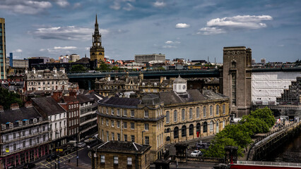 Newcastle upon Tyne cityscape showing All Saints' Church, Tyne Bridge and the Guildhall on a cloudy day