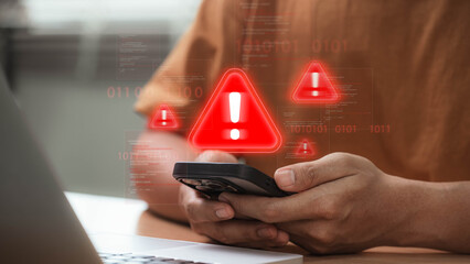 Cybersecurity threat warning on smartphone with red alert icon signaling hacking attempt, virus infiltration, and data breach while user checks phone at home, showing mobile cyberattack risk