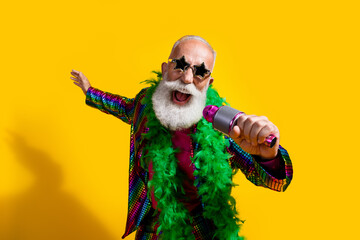 Photo of elderly cool old man singing karaoke wear stylish striped suit boa sunglass isolated on...