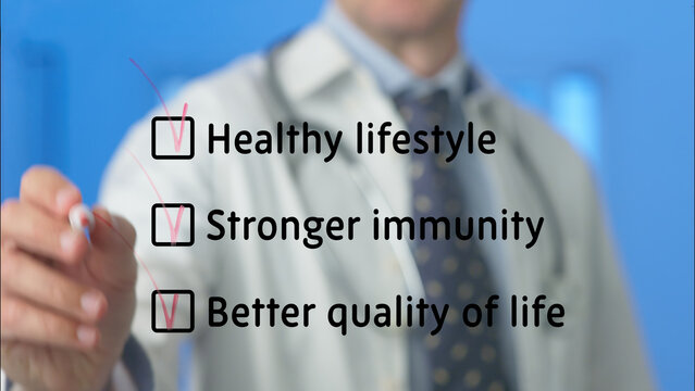 Doctor is ticking checkboxes of healthy lifestyle, stronger immunity and better quality of life, highlighting the importance of these factors for overall well being