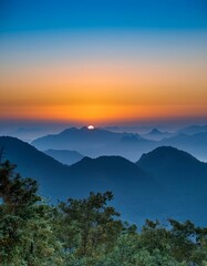 Breathtaking Scenic Sunset Over Mountain Range Golden Hour Landscape Photography, Blue and Orange Sky, Serene Nature View, Majestic Peaks