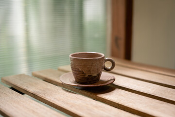 Vintage coffee cups on a wooden table in the morning.