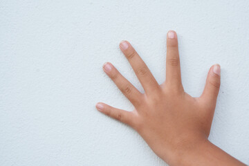 The boy is gesturing on a white background.