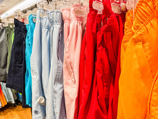 Colorful display of shorts in retail store showcases variety of styles and shades available for...