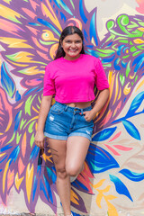 Smiling Latina Woman Holding Sunglasses and Looking at Camera