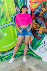 Trendy Latina Girl Posing in Front of Urban Graffiti Wall