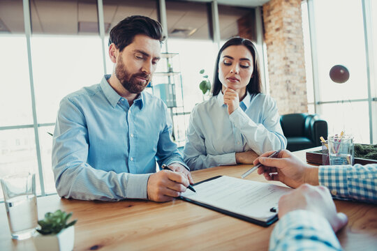 Professional business discussion during an office meeting with diverse young coworkers evaluating documents and agreements