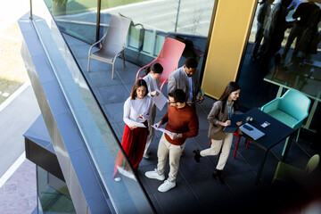Team brainstorming and collaboration on a terrace during a sunny afternoon in a modern setting